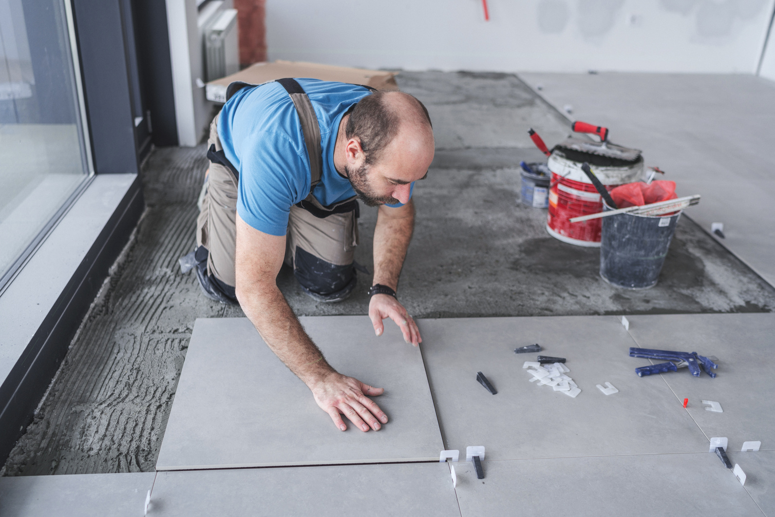 Tile professional installing floor tile